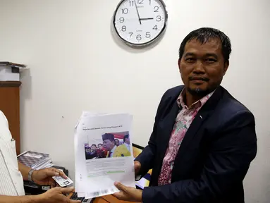 Koordinator Masyarakat Anti Korupsi Indonesia (MAKI) Boyamin Saiman (kanan) menyerahkan laporan ke Mahkamah Kehormatan Dewan (MKD) DPR, Jakarta, Kamis (16/3). Ketua DPR Setya Novanto dilaporkan terkait kasus korupsi e-KTP. (Liputan6.com/Johan Tallo)
