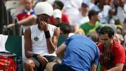 Petenis asal Jerman, Dustin Brown menangis saat tim medis mengobati cidera yang di alaminya saat bertanding di Olimpiade Rio 2016 melawan Thomaz Bellucci asal Brasil, Brasil (7/8). (REUTERS/Kevin Lamarque)