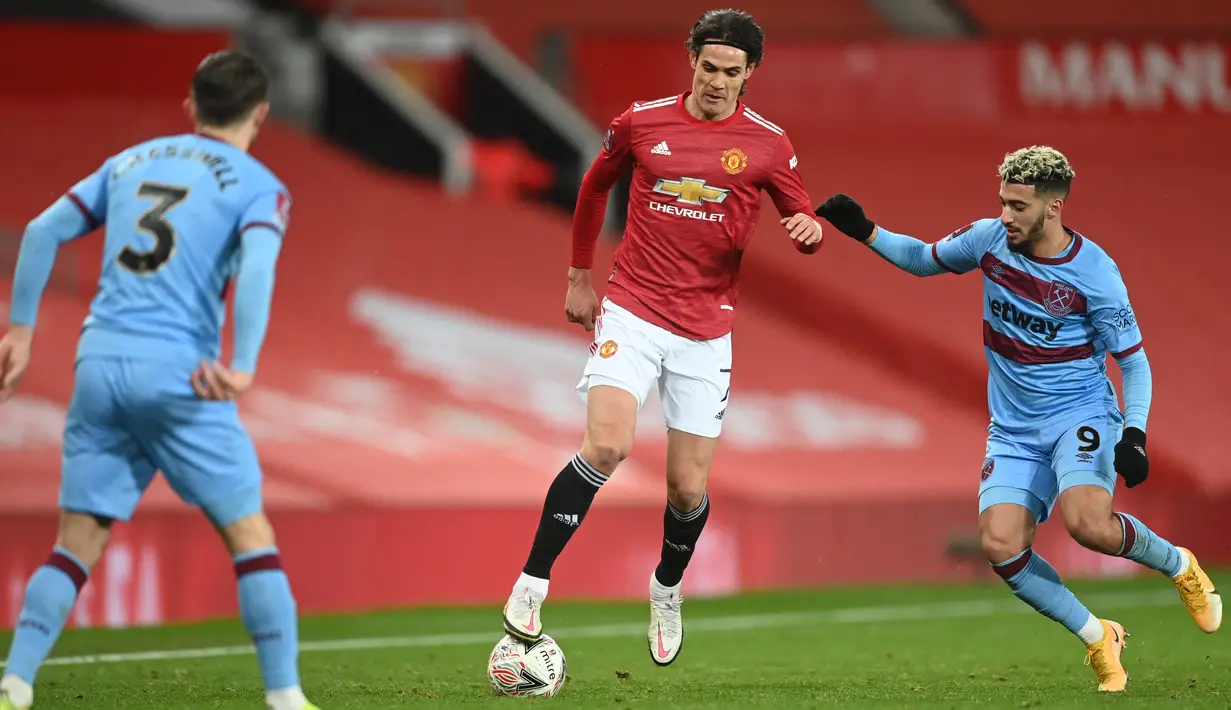Striker MU, Edinson Cavani (tengah) membawa bola dari kawalan bek West Ham United Aaron Cresswell (kiri) dan gelandang Said Benrahma pada pertandingan perdelapan final Piala FA di Old Trafford, Inggris (10/2/2021). Kemenangan ini membuat MU lolos ke perempat final Piala FA. (Michael Regan/POOL/AFP)