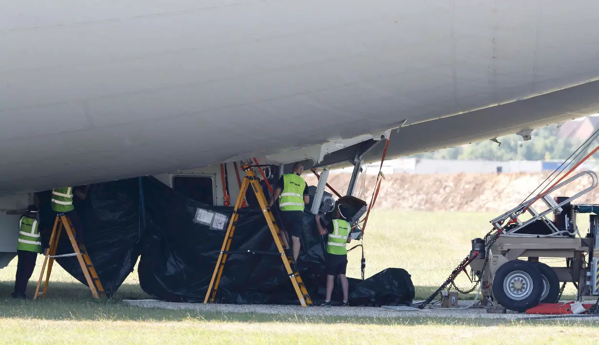 Pekerja mencoba memperbaiki kerusakan pesawat Airlander 10 yang gagal mendarat di Cardington Airfield, Inggris, Rabu (24/8). Pesawat senilai Rp439 M ini mengalami gangguan dan menukik tajam sebelum jatuh di landasan saat mendarat (REUTERS/Darren Staples)