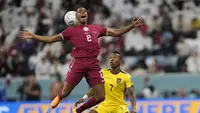 Bek Qatar, Pedro Miguel berebut bola dengan bek Ekuador, Pervis Estupinan pada pertandingan grup A Piala Dunia 2022 di Stadion Al Bayt di Al Khor, Qatar, Minggu (20/11/2022). Ekuador berhak memimpin klasemen sementara dengan koleksi tiga poin. (AP Photo/Darko Bandik)