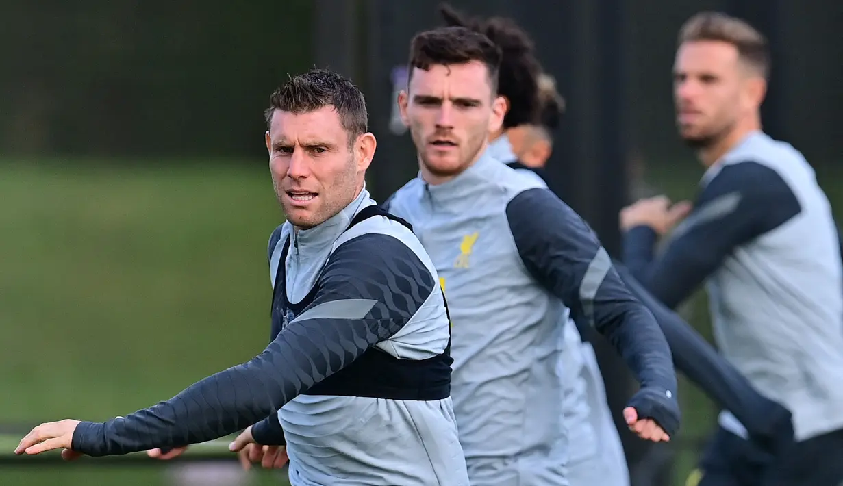 Gelandang Liverpool, James Milner melakukan pemanasan selama sesi latihan di pusat pelatihan Axa di Kirkby, Liverpool, Inggris (27/9/2021). Liverpool akan bertanding melawan Porto pada grup B Liga Champions di Estadio do Dragao. (AFP/Paul Ellis)