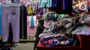 Pedagang gamis dan baju anak menunggu pembeli di kiosnya di pasar Parung, Bogor, Jawa Barat, Kamis (18/2/2021). Dampak pandemi COVID-19 yang berkepanjangan pedagang mengaku omset penjualan gamis dan baju anak turun 85 persen semenjak awal tahun lalu hingga sekarang. (Liputan6.com/Johan Tallo)