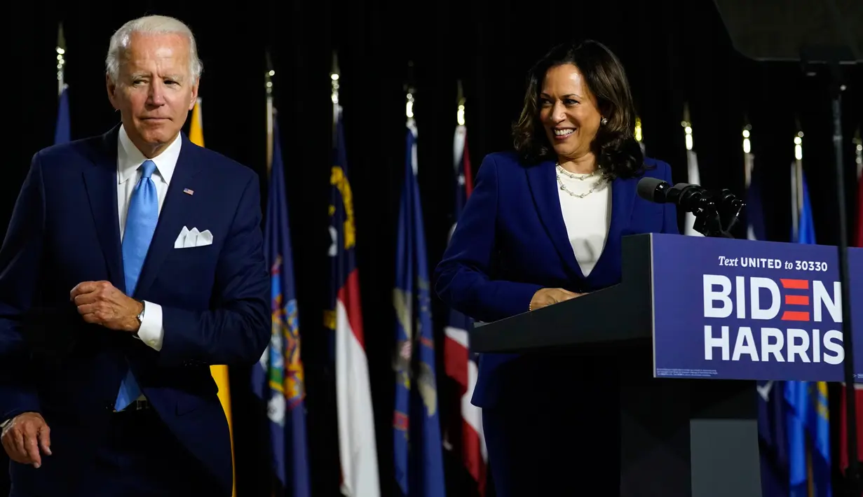 Calon Presiden dan Calon Wakil Presiden Partai Demokrat, Joe Biden dan Kamala Harris melepaskan masker saat berbicara di atas podium di Alexis Dupont High School di Wilmington, Rabu (12/8/2020). Keduanya tampil perdana di depan publik sebagai pasangan capres-cawapres. (AP Photo/Carolyn Kaster)