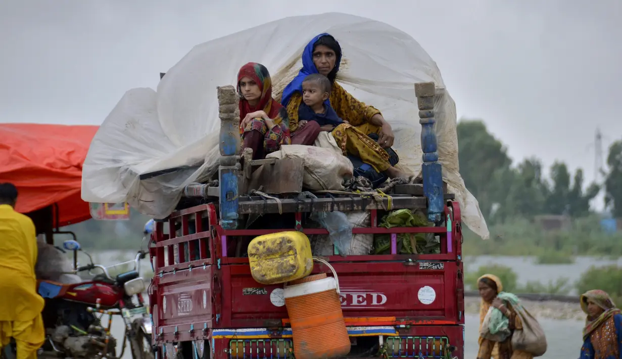 Sebuah keluarga pengungsi naik becak saat bepergian ke daerah yang aman setelah melarikan diri dari rumah mereka yang dilanda banjir, di Jaffarabad, sebuah distrik di provinsi Baluchistan barat daya Pakistan, Rabu (24/8/2022). Di Pakistan sejak pertengahan Juni, menyebabkan 903 orang tewas dan sekitar 50.000 orang kehilangan tempat tinggal, kata badan bencana negara itu. (AP Photo/Zahid Hussain)
