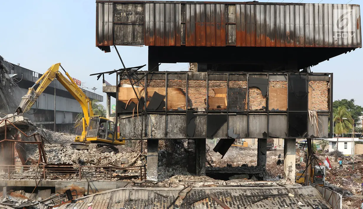 Petugas menggunakan alat berat merobohkan bangunan Pasar Senen di Jakarta, Senin (11/9). Pemerintah Provinsi DKI Jakarta melakukan revitalisasi terhadap Pasar Senen Blok I dan Blok II yang terbakar beberapa waktu lalu. (Liputan6.com/Immanuel Antonius)