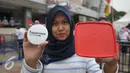 Pengunjung memperlihatkan Tupperware, Jakarta, Selasa (12/4).2500 Tupperware dibagikan secara gratis sebagai dukungan untuk membangun pola hidup sehat, hemat, dan ramah lingkungan melalui kebiasaan membawa bekal. (Liputan6.com/Gempur M Surya)
