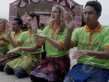 Peserta pertukaran pelajar Indonesia - Canada membawakan tarian Saman asal Aceh dalam acara "Tidung Festival 2015" yang digelar di Pulau Tidung, Kepulauan Seribu, Jakarta, Sabtu (7/3/2015). (Liputan6.com/Andrian M Tunay)