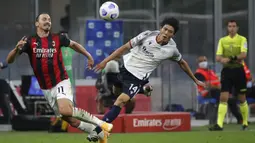 Pemain AC Milan Zlatan Ibrahimovic (kiri) berebut bola dengan pemain Bologna Takehiro Tomiyasu pada pertandingan Serie A di Stadion San Siro, Milan, Italia, Senin (21/9/2020). AC Milan menaklukkan Bologna 2-0. (AP Photo/Antonio Calanni)