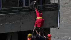 Personel kepolisian mengevakuasi warga yang terjebak dari sebuah rumah yang tertimbun lumpur akibat banjir bandang di Trishuli, Distrik Nuwakot, Nepal, Kamis, pada 27 Agustus 2026. (AFP/ Arun Sankar)
