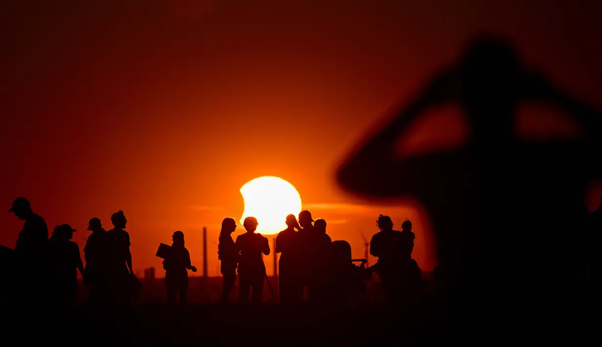 Warga menyaksikan gerhana matahari sebagian di taman lanskap Halde Hoheward di Herten, Jerman bagian barat, Rabu, 12 Agustus 2026.(AFP/Ina Fassbender)