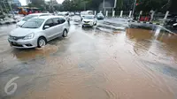 Sejumlah pengendara mobil melaju melewati genangan air hujan yang merendam jalan di depan Istana Merdeka, Jakarta, Selasa (9/2). Hujan deras yang mengguyur kota Jakarta membuat sejumlah jalan protokol tergenang air. (Liputan6.com/Immanuel Antonius)
