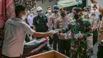 Pangdam Jaya Mayjen TNI Dudung Abdurrachman (kanan) dan Kapolda Metro Jaya Irjen Pol Fadil Imran membagikan masker kepada warga di Sunter Muara, Tanjung Priok, Jakarta, Selasa (9/2/2021). Kegiatan ini untuk menyadarkan masyarakat akan pentingnya penggunaan masker. (Liputan6.com/Faizal Fanani)