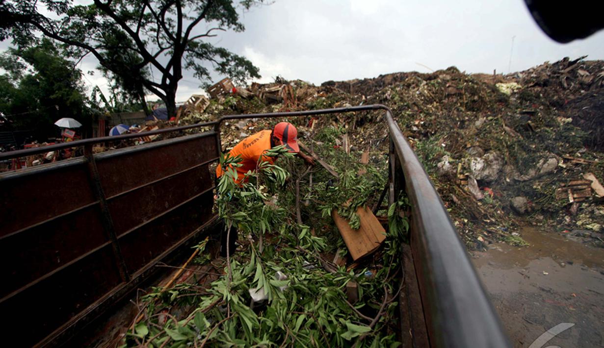 Petugas kebersihan saat mengeluarkan sampah di dalam truk di Pasar Induk Kramatjati,  Jakarta, Kamis (8/1/2015). (Liputan6.com/Faizal Fanani)