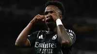 Penyerang Real Madrid asal Brasil bernomor punggung 07, Vinicius Junior, merayakan gol pembuka saat pertandingan leg kedua babak 16 besar Liga Champions UEFA antara Manchester City dan Real Madrid di Stadion Etihad di Manchester, barat laut Inggris, pada 18 Maret 2026. (Paul ELLIS/AFP)