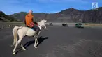 Joki kuda sedang menunggu wisatawan yang melintas menggunakan mobil jeep di Taman Nasional Bromo Tengger Semeru, Jawa Timur, Sabtu (4/11). Harga sewa kuda berkisar Rp 100 - 150 ribu. (Liputan6.com/Fery Pradolo)