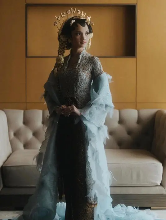 Keunikan kebaya ini terletak pada selendang panjang warna putih berbahan pleated organza yang memberikan kesan modern pada kebaya Sabrina. (Instagram/weddingku).