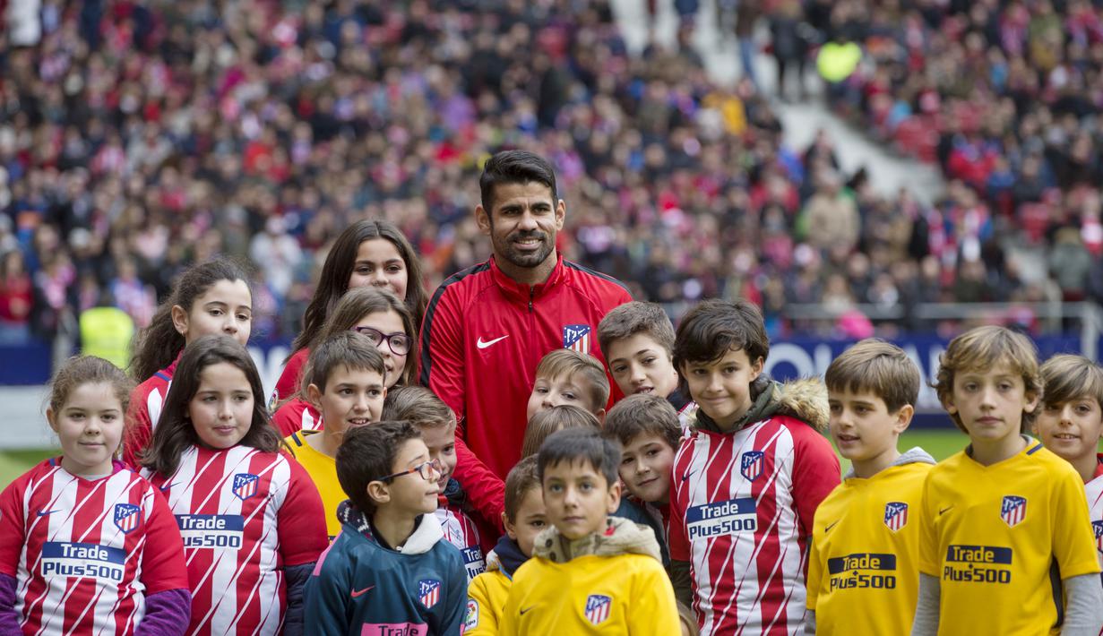 Striker Atletico Madrid, Diego Costa, foto bersama anak-anak saat diperkenalkan di Stadion Wanda Metropolitan, Madrid, Minggu (31/12/2017). Diego Costa resmi kembali berseragam Atletico Madrid setelah terdepak dari Chelsea. (AP/Paul White)