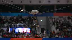 Spidercam saat merekam laga Piala Dunia FIBA 2023 antara Kanada melawan Lebanon di Indonesia Arena, Senayan, Jakarta, Minggu (27/08/2023). Jenis kamera ini ditempatkan di atas lapangan dan mampu bergerak fleksibel. Teknologi inilah yang membuat penonton mampu merasa lebih dekat dengan lapangan. (Bola.com/Bagaskara Lazuardi)