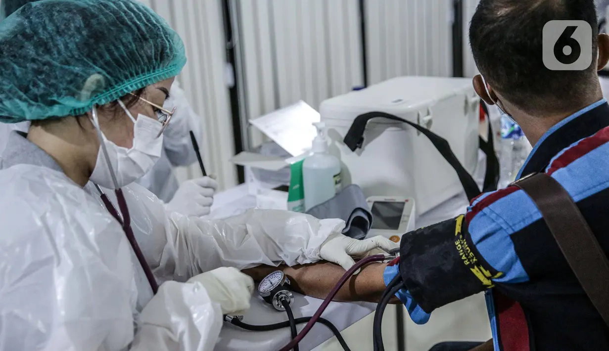 Petugas medis memeriksa kondisi pekerja ritel sebelum divaksin COVID-19 Astrazeneca di GOR Tanjung Duren, Jakarta Barat, Senin (24/5/2021). Berdasarkan data Kementerian Kesehatan hingga 23 Mei 2021, sebanyak 14.890.933 orang telah menerima vaksin COVID-19 dosis pertama. (Liputan6.com/Faizal Fanani)