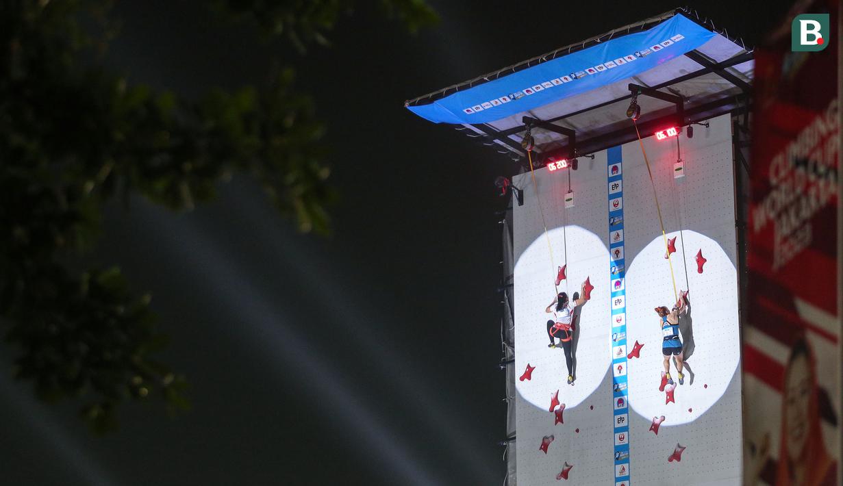 Atlet panjat tebing Indonesia, Desak Made Rita Kusuma (kiri) berkompetisi melawan atlet panjat tebing Polandia, Chudziak Patrycja pada nomor speed putri 16 besar Kejuaraan Dunia Panjat Tebing IFSC 2023 seri Jakarta melawan atlet panjat tebing China, Xinshang Wang di Lot 6, Kompleks Stadion Utama Gelora Bung Karno, Jakarta, Indonesia, Minggu (07/05/2023). (Bola.com/Bagaskara Lazuardi)