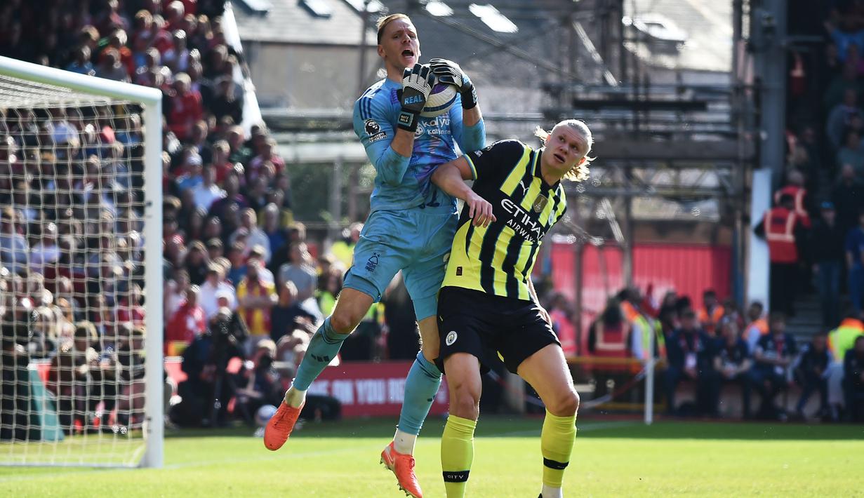 Pemain Manchester City, Erling Haaland, duel udara dengan pemain Nottingham Forest, Matz Sels, dalam laga pekan ke-28 Premier League 2024/2025 di City Ground, Sabtu (8/3/2025) malam WIB. (AP Photo/Rui Vieira)