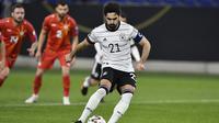 Gelandang Jerman, Ilkay Gundogan melakukan eksekusi penalti yang berbuah gol penyeimbang 1-1 ke gawang Makedonia Utara dalam laga lanjutan Kualifikasi Piala Dunia 2022 Zona Eropa Grup J di Duisburg, Jerman, Rabu (31/3/2021). Jerman kalah 1-2 dari Makedonia Utara. (AP/Martin Meissner)
