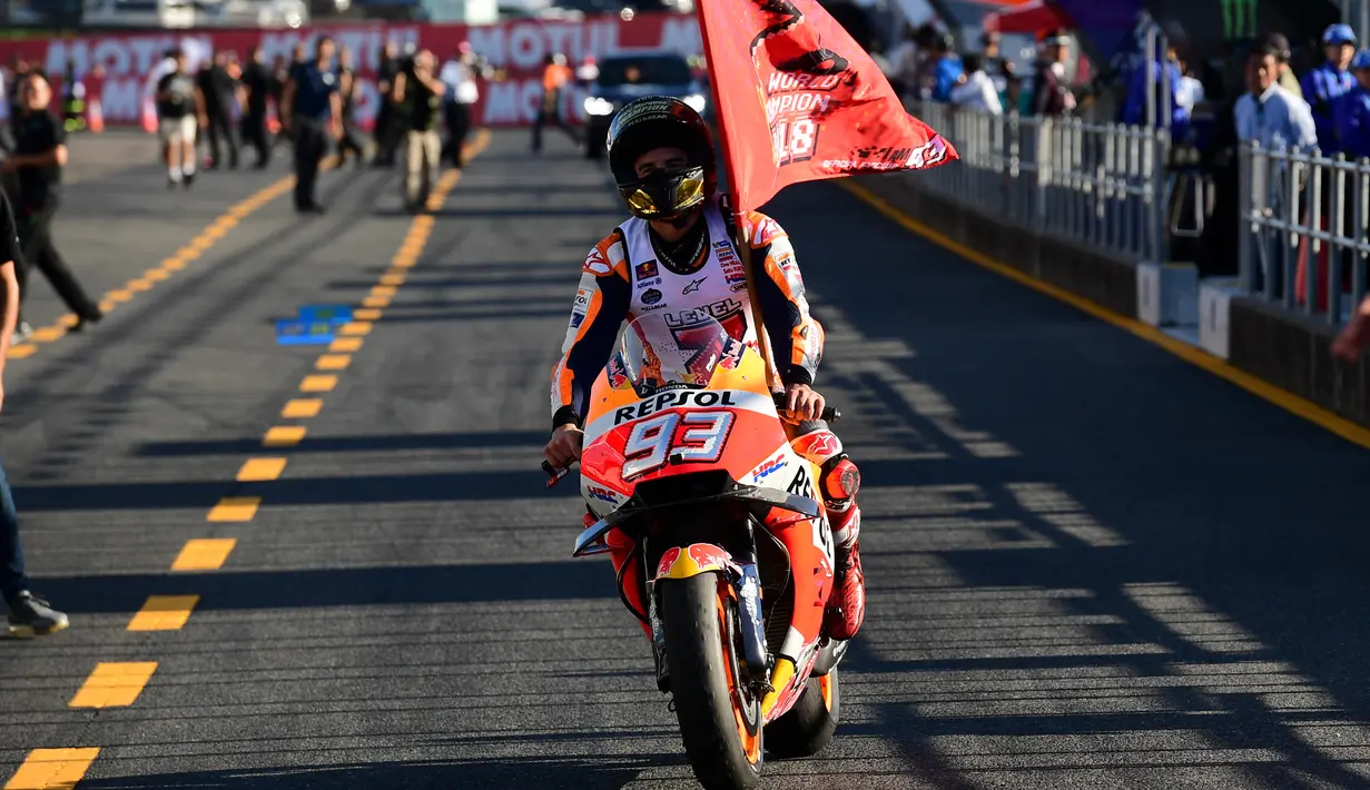Pembalap Repsol Honda asal Spanyol, Marc Marquez tiba di pit balapan MotoGP Jepang 2018 setelah finis terdepan di Twin Ring Motegi, Minggu (21/10). Marquez menjadi pemenang dengan catatan waktu 42 menit 36,438 detik. (Martin BUREAU / AFP)