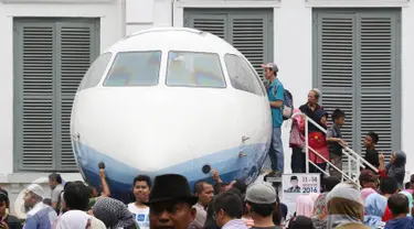 Pengunjung antre untuk masuk ke Pesawat N250 pada Habibie Festival di Museum Nasional, Jakarta, Minggu (14/8). Tingginya antusiasme warga membuat pengunjung harus antre untuk dapat melihat bagian dalam kendaraan tersebut. (Liputan6.com/Immanuel Antonius)