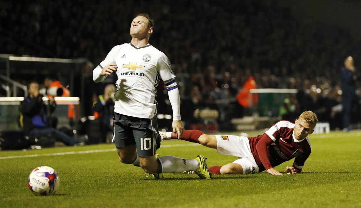 Wayne Rooney dihadang pemain Northampton Town, Alfie Potter  pada piala liga Inggris di Sixfields Stadium, (22/9/2016) dini hari WIB. (Action Images via Reuters/John Sibley)