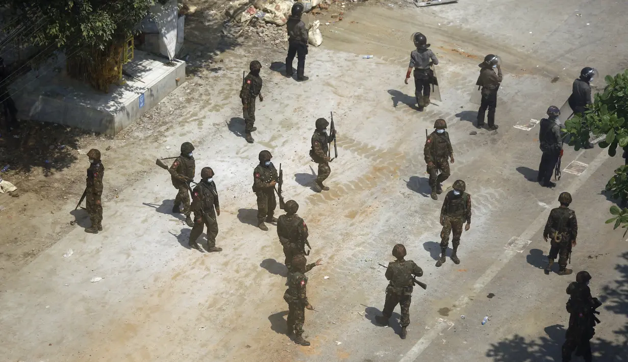 Tentara dan polisi berkumpul di jalan ketika pengunjuk rasa mengadakan demonstrasi menentang kudeta militer di Yangon (6/3/2021). (AFP Photo)