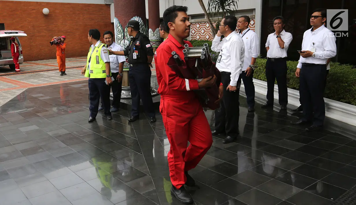 Petugas Airport Rescue & Fire Fighting Officer membawa tandu lipat di Gedung VIP Terminal 1B, Bandara Internasional Soekarno-Hatta, Tangerang, Senin (29/10). Antemortem adalah data-data fisik khas korban sebelum meninggal. (Liputan6.com/Fery Pradolo)