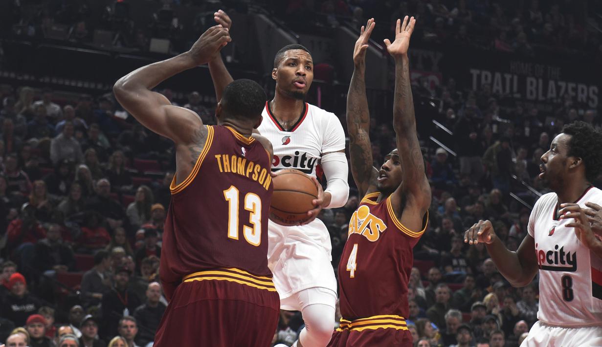 Pemain Portland Trail Blazers, Damian Lillard mencoba keluar dari tekanan para pemain Cleveland Cavaliers pada laga NBA basketball game di oda Center, Portland (11/1/2016). Blazers menang 102-86.  (AP/Steve Dykes)