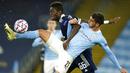 Penyerang Manchester City, Ferran Torres, berebut bola dengan pemain Olympiakos, Pape Abou Cisse, pada laga Liga Champions di Stadion Etihad, Rabu (4/11/2020). Manchester City menang dengan skor 3-0. (AP/Dave Thompson)