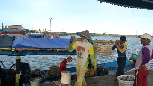 Nelayan Cilacap memikul ikan usai melaut. (Foto: Liputan6.com/Muhamad Ridlo)