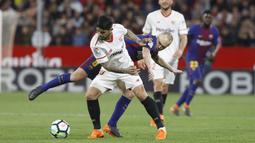 Aksi pemainBarcelona, Andres Iniesta (belakang) saat berebut bola dengan pemain Sevilla, Banega pada laga La Liga Santander di Sanchez Pizjuan stadium, (31/3/2018). Barcelona bermain imbang 2-2 dengan Sevilla. (AP/Miguel Morenatti)