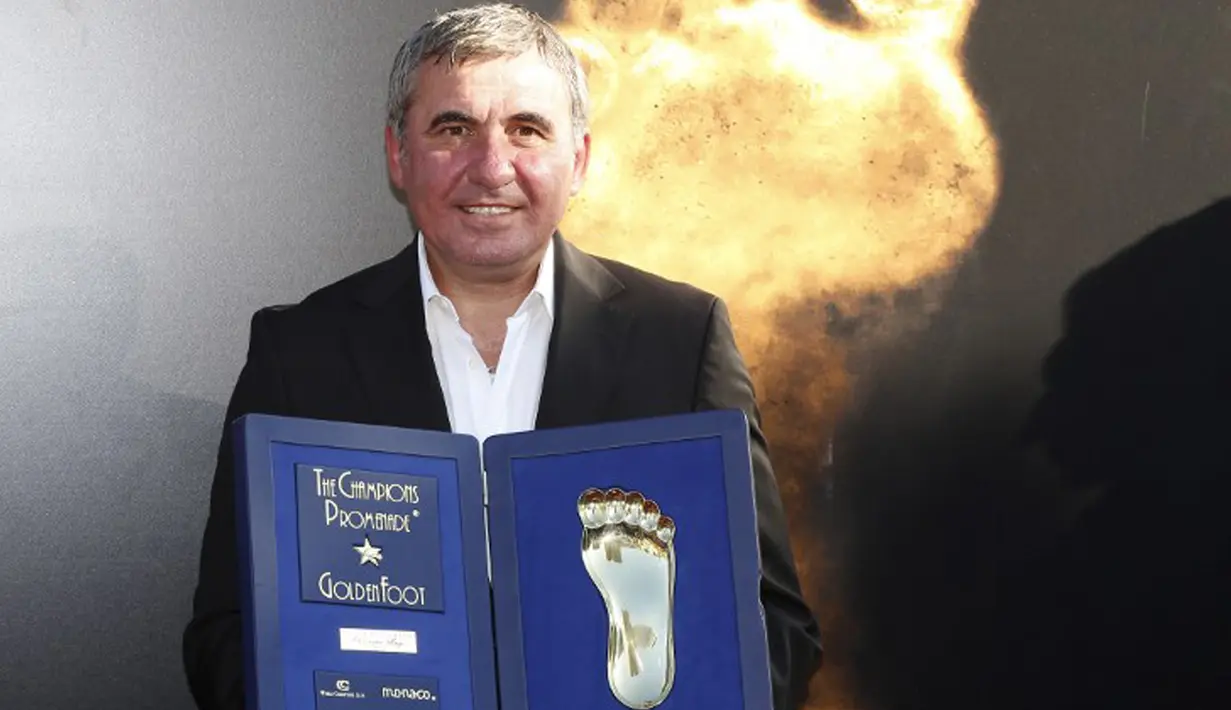 Pemain Rumania, Gheorghe Hagi berpose dengan trofi Golden Foot miliknya, Monaco, Senin (21/9/2015). Golden Foot 2015 diraih lima orang yaitu Rinat Dasaev, Daniel Passarella, Gheorghe Hagi,  Trezeguet dan Eto'o. (AFP Photo/Valery Hache)