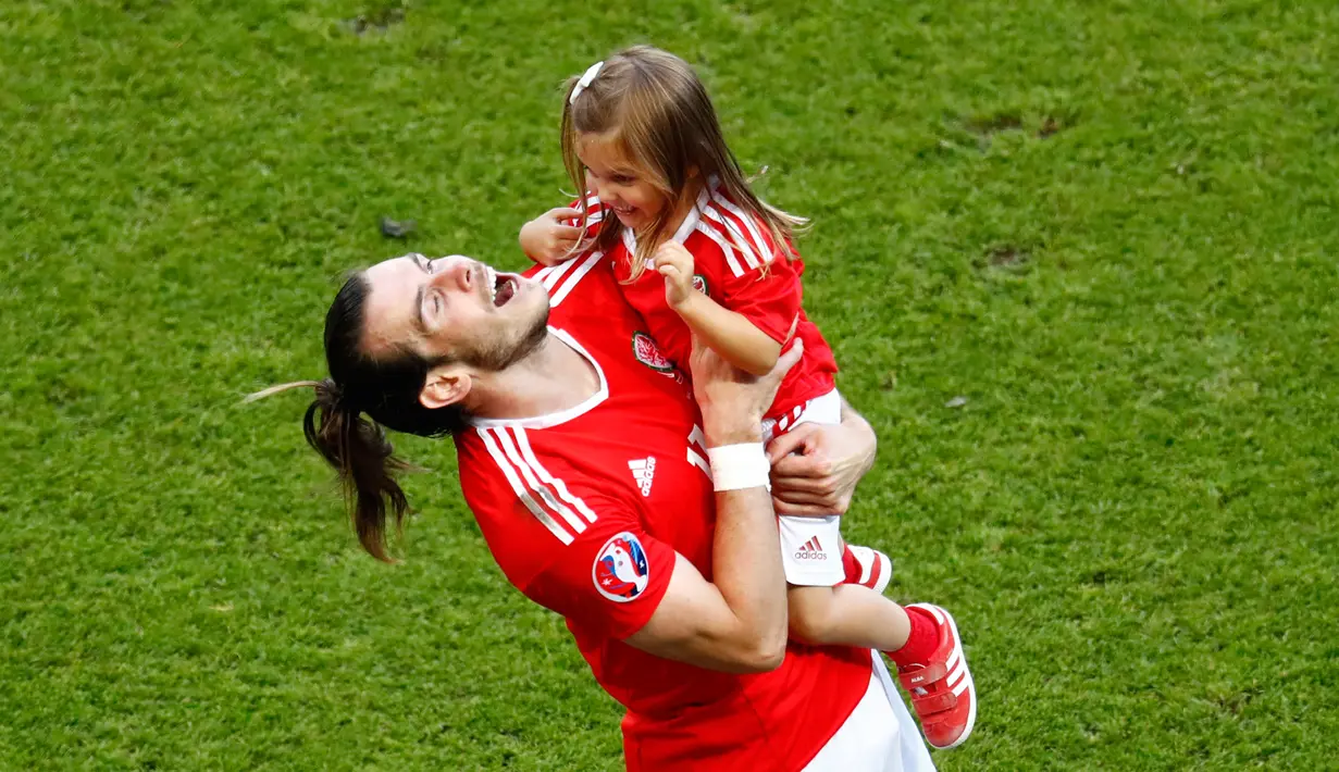 Wales unggul 1-0 atas Irlandia Utara di babak 16 besar Euro 2016 di Parc des Princes, Paris, Prancis, Minggu (26/6). Tampak Bale bermain bersama putrinya usai pertandingan. (REUTERS/ Christian Hartmann)