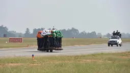 Aksi anggota Tornado dari Army Service Corps (ASC) membawa 58 orang dengan satu motor 500 cc di Bangalore (19/11). Tim Tornado memecahkan rekor sebelumnya dari 56 pria yang dimenangkan Army Signal Corps (Daredevils) pada 2010. (AFP Photo/Manjunath Kiran)