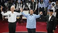 Tiga Calon Presiden, Ganjar Pranowo, Prabowo Subianto dan Anies Baswedan (kiri ke kanan) mengangkat tangan usai debat perdana Pilpres 2024 di halaman Gedung Komisi Pemilihan Umum (KPU), Selasa (12/12/2023). (Liputan6.com/Faizal Fanani)