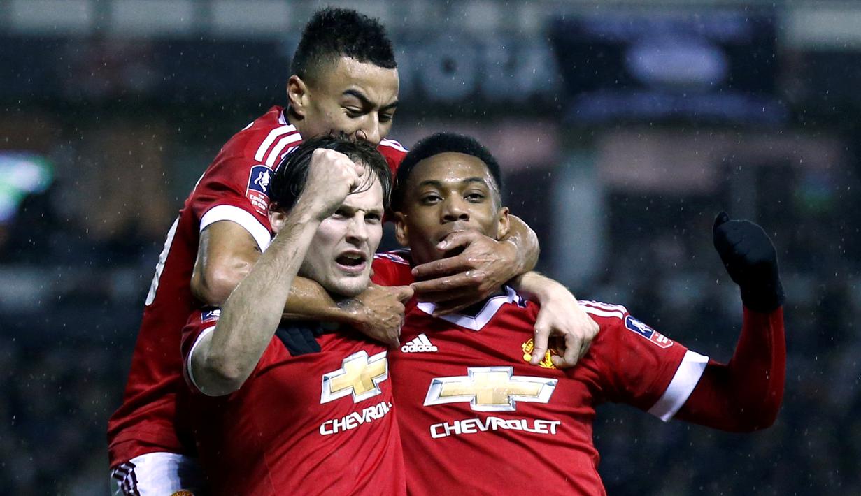 Pemain MU, Daley Blind, disambut rekan-rekannya setelah mencetak gol ke gawang Derby County dalam laga putaran keempat Piala FA, di Stadion Pride Park, Sabtu (30/1/2016) dini hari WIB. (Reuters/Eddie Keogh)