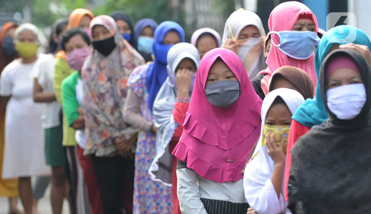 Warga terdampak Covid-19 antre mengambil bahan pangan gratis di Kompleks Bumi Menteng Asri, Rt 01/18, Kelurahan Menteng, Bogor, Kamis (21/5/2020).  Bahan pangan tersebut disediakan secara swadaya warga setempat dan sudah berjalan selama Bulan Ramadan. (merdeka.com/Arie Basuki)