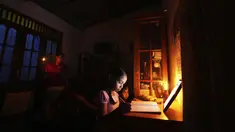 Gadis Sri Lanka menggunakan lampu minyak tanah untuk sekolah online saat pemadaman listrik di Kolombo, 4 Maret 2022. Krisis keuangan negara memaksa anak-anak belajar menggunakan lampu minyak tanah, nelayan mengurangi penangkapan ikan dan industri membatasi produksi. (AP Photo/Eranga Jayawardena)