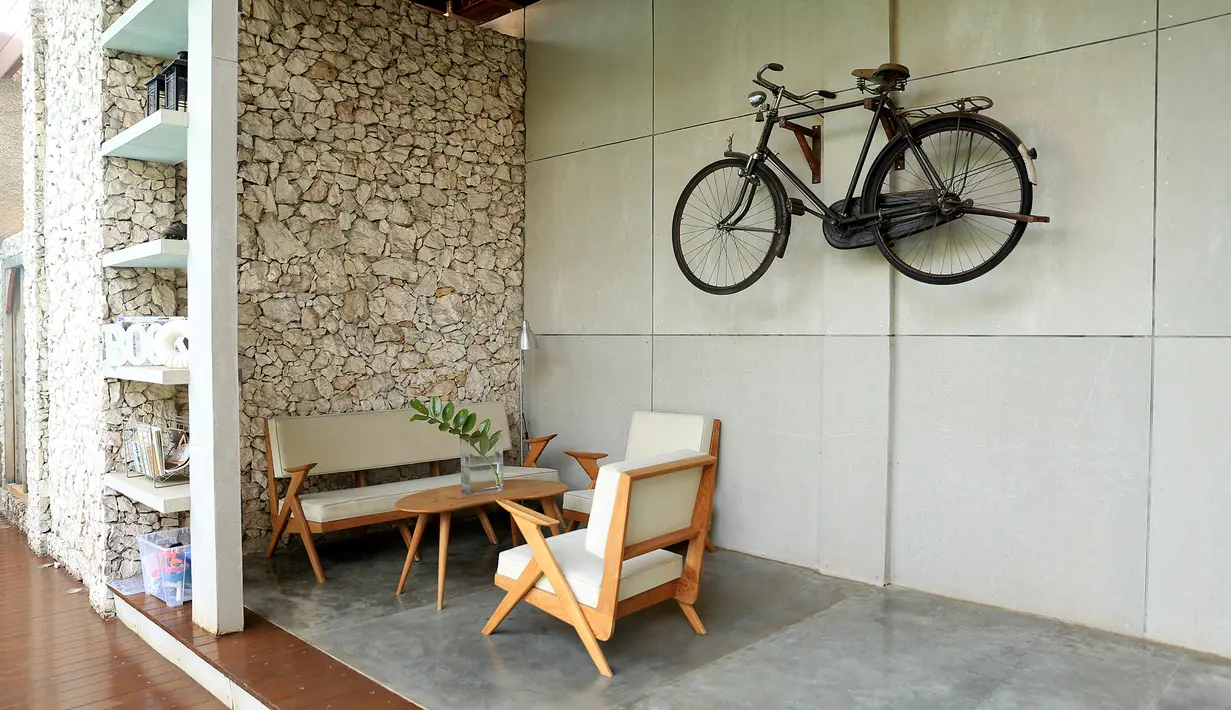 Tampak juga seperangkat kursi untuk bersantai, uniknya adanya sebuah sepeda yang digunakan sebagai hiasan di dinding. (Andy Masela/Bintang.com)