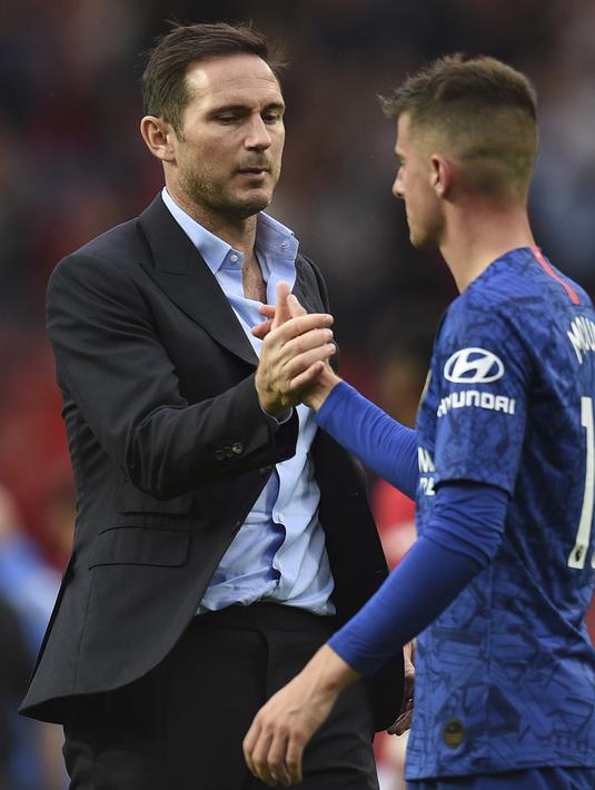 Pelatih Chelsea, Frank Lampard  berjabat tangan dengan gelandang Mason Mount usai pertandingan melawan MU pada pertandingan perdana Liga Inggris di Old Trafford  (11/8/2019). MU menang telak 4-0 sekaligus menjadi mimpi buruk bagi debut Frank Lampard bersama Chelsea. (AFP Photo/Oli Scarff)