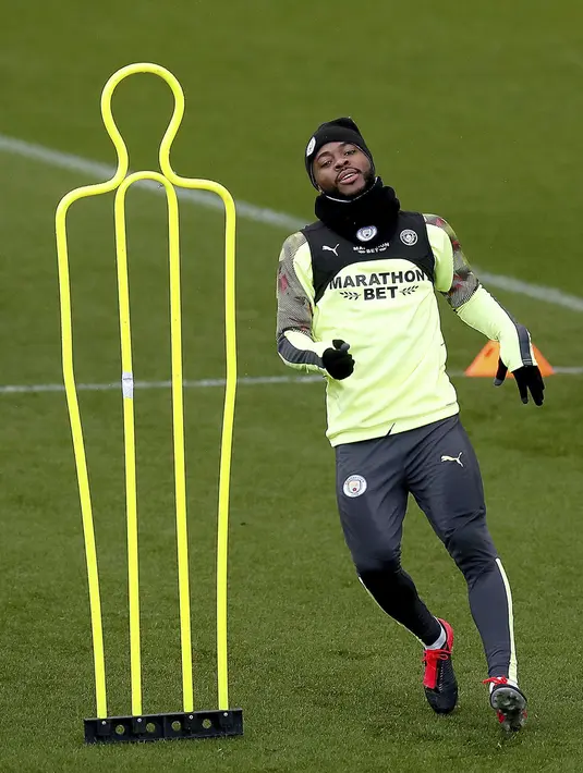 Penyerang Manchester City, Raheem Sterling melakukan pemanasan selama sesi latihan di City Football Academy, Manchester, Inggris (25/2/2020). City akan bertanding melawan Real Madrid pada leg pertama babak 16 Liga Champions di Bernabeu. (Martin Rickett/PA via AP)