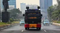 Suasana saat kendaraan water canon Brimob Polda Metro Jaya menyemprotkan air di Jalan Sudirman - Thamrin. (Liputan6.com/Angga Yuniar)