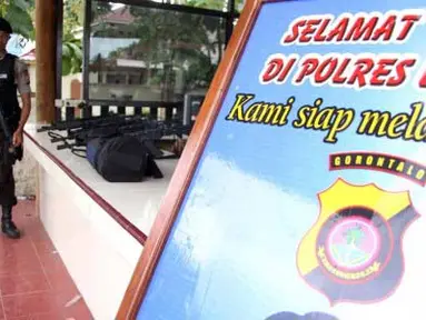Seorang anggota Polisi lengkap dengan senjata laras panjang bersiaga di Mapolres Limboto, Gorontalo, Kamis (26/4). Polisi memperketat pengamanan pasca meninggalnya Prada Firman anggota Yonif 713 Kostrad, korban bentrokan antara Brimob Polda Gorontalo dengan sejumlah personel batalyon infanteri tersebut. (Antara)