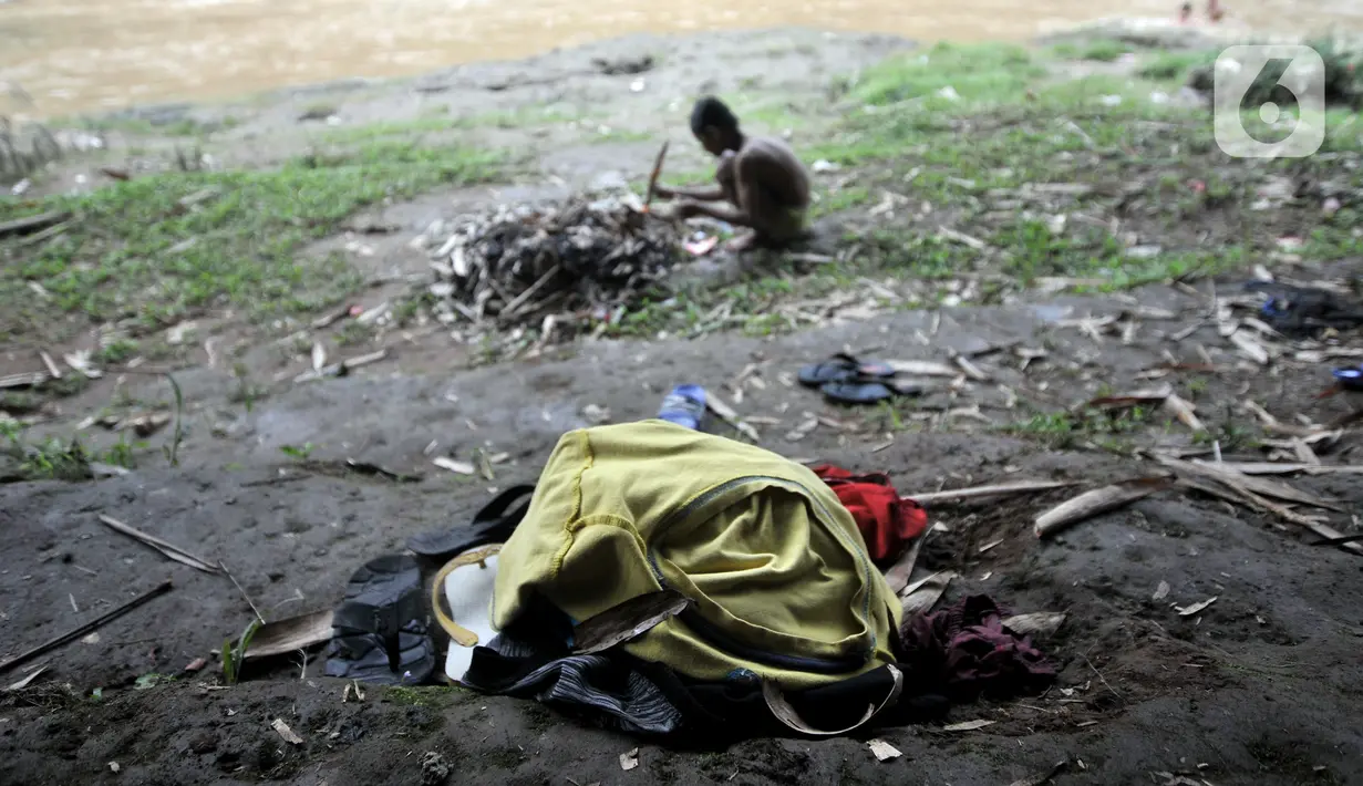 Tumpukan pakaian anak-anak saat berenang di Kali Ciliwung, Depok, Jawa Barat, Minggu (27/6/2021). Keterbatasan lahan bermain di tengah masa pandemi COVID-19 membuat anak-anak memilih untuk berenang di Kali Ciliwung sebagai wahana alternatif saat libur sekolah. (merdeka.com/Iqbal S. Nugroho)