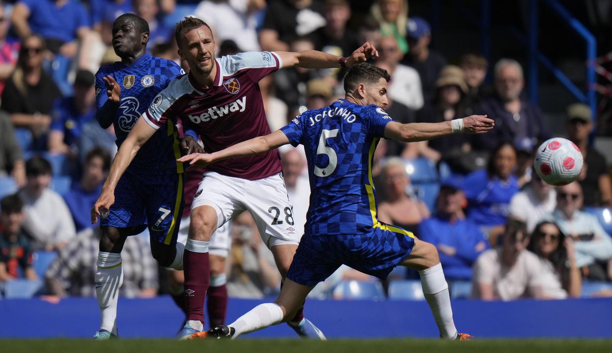 <p>Gelandang West Ham United, Tomas Soucek berebut bola dengan dua pemain Chelsea, Jorginho dan N'Golo Kante saat pertandingan lanjutan Liga Inggris di Stamford Bridge di London, Minggu (24/4/2022). Dengan kemenangan ini, Chelsea menjaga posisi tiga dengan kini mengoleksi 65 poin dari 32 laga. (AP Photo/Alastair Grant)</p>